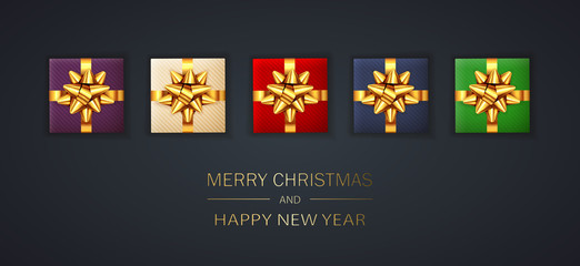 Christmas Gifts with Golden Holiday Bow on Black Background