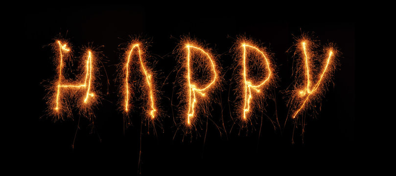 The word HAPPY written with a sparkler