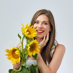 Happy woman with toothy smile holding sunflowers bouquet.