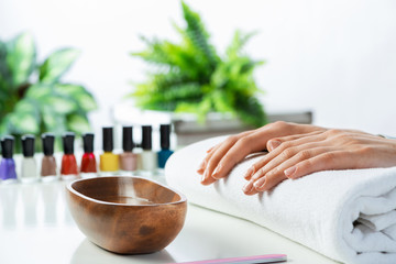 Female hands lying on white towel