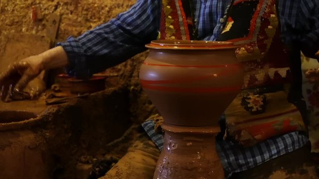 Experienced master doing a pot on a pottery wheel, Chez Galip make a pot, hands forms clay pot on potter's wheel, Hands working on pottery wheel, Traditional and Manual Pottery Production