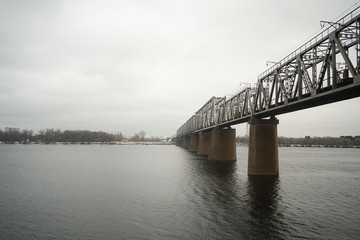 Railway bridge over Dnipro river in Kyiv. Industrial steel bridge across the river.