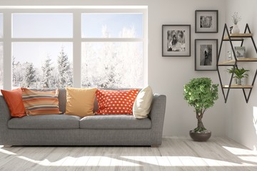 Stylish room in white color with sofa and winter landscape in window. Scandinavian interior design. 3D illustration
