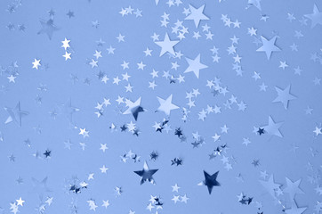 Classic blue background with confetti stars.
