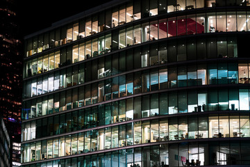 Modern offices in a large glass fronted building at night