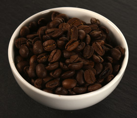 coffee beans in cup on stone background