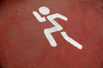 running sign is on the plastic runway