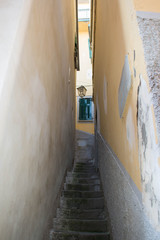 Fototapeta na wymiar A narrow street with stairs leading up.