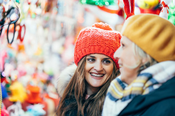 Retired woman and young woman doing Christmas shopping.
