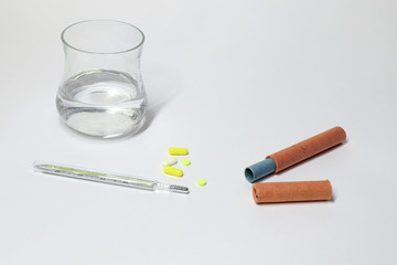 thermometer for measuring body temperature mercury, tablets, a glass of water. treating illness