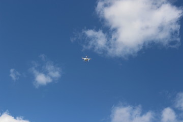 Drone against the blue sky on a sunny day. quadcopter flying through the sky. Aerial photo and video technology