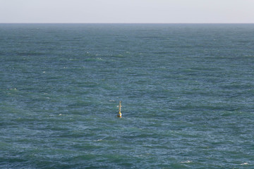 Horizon line over sea and buoy. Seascape.