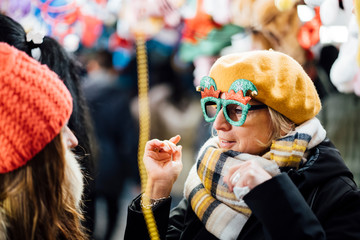 Retired woman and young woman doing Christmas shopping.