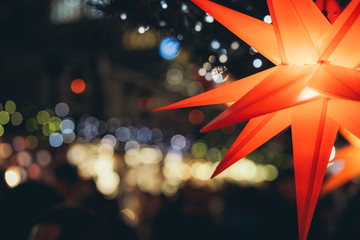 Red colored stars illuminated with light on Xmas tree at Christmas Market in Hamburg, Germany