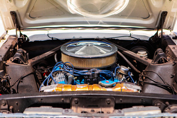 old classic open hood car with v8 engine and big chromed round air intake filter with blue Candles...