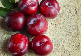 Fresh ripe plums on the light background. Top view