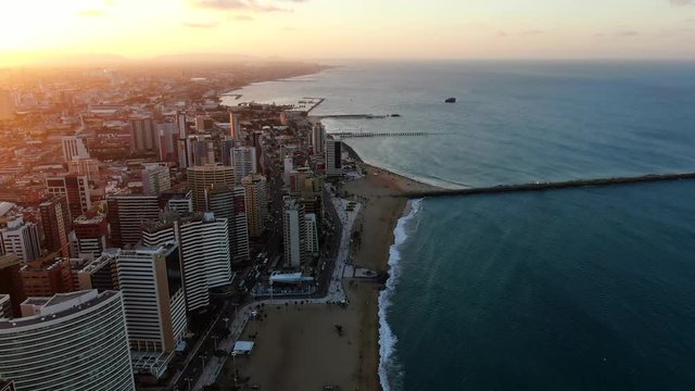 Aerial view of city Fortaleza. Luxury resorts and hotels, skyscrapers on the coast line. Beautiful beaches. City view during sunset. 