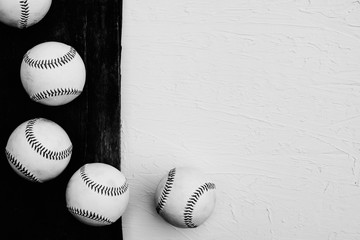 Rustic baseball background in black and white with top view of balls on wood, copy space for sports text.