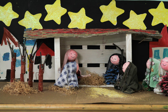 Realistic christmas nativity scene with figurines including Jesus and domestic animals