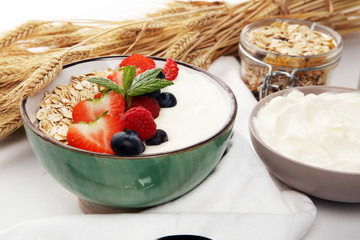 Tasty homemade granola served on table. Healthy breakfast with a bowl of oatmeal with banana, blueberries, strawberries and healthy food for Breakfast