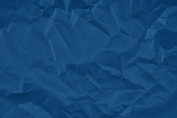 Trendy classic blue colored textured background. Crumpled satine paper texture. Flat lay.  2020...
