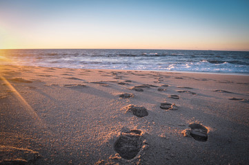 Beautiful landscape at sunset,  footprints in the sand 