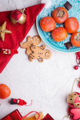 jolly traditional  Christmas set with gifts  and fruits around white background. flat lay