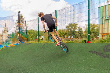 bmx bicycle rider tricking. Extreme BMX rider. Boy jump in skatepark on competition. Sport bicycle...