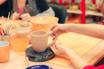 The process of creating a ceramic cup on a potter's wheel