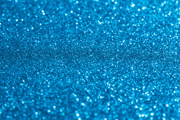 Blurred shiny Christmas lights toned blue color