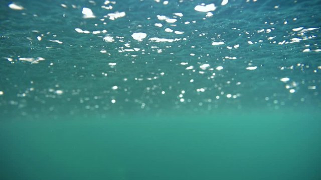 Underwater view of rainy water surface