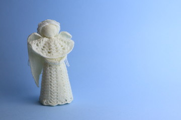 Beautiful knitted Christmas angel on colorbackground