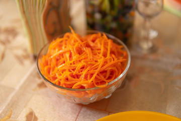 The carrot in Korean, a transparent orange in the bowl is on the table