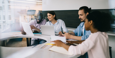 Multiethnic employees developing project together at official office meeting