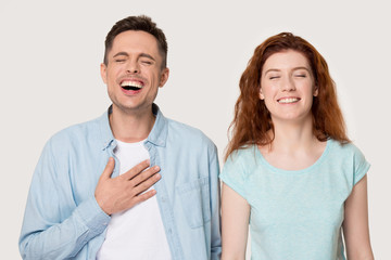 Sincere young family couple laughing portrait.