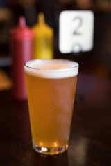 Pint of beer on a burger restaurant table