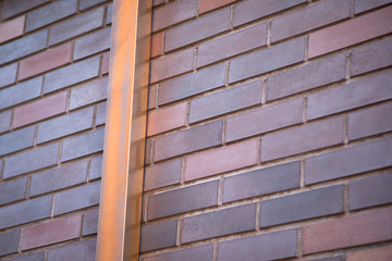 Copper gutter downspout on a brick building