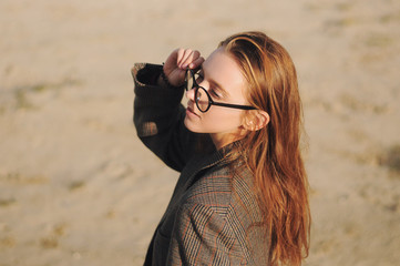 Young hipster girl posing outdoors, outdoor fashion portrait, sunglasses, street style, red lips...