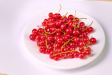 Fresh washed berries of red currant on the background