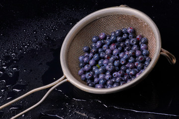 Fresh washed blueberries with drops of water on a background