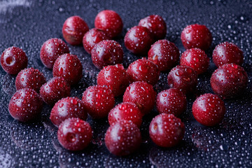 Fresh washed cherry berries with water drops on a background