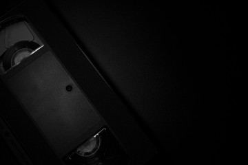 old VHS video cassette against a dark background in black and white