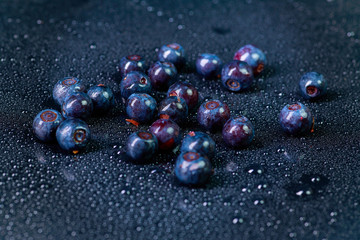 Fresh washed blueberries with drops of water on a background