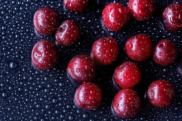 Fresh washed cherry berries with water drops on a background