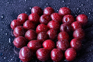 Fresh washed cherry berries with water drops on a background