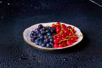 Fresh washed blueberries with drops of water on a background