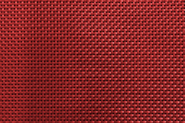 dark red abstract interwoven texture of plastic strings