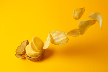 potato chips fly on a yellow background, the process of making chips, fast food levitation