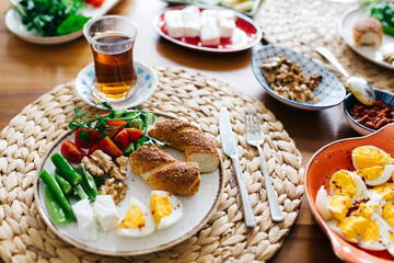 Turkish traditional Breakfast with bagel (Turkish Simit), blur background and in front of the photo there is Turkish Bagel