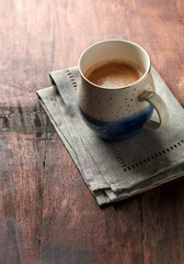 Mug of coffee on rustic wooden background. Copy space.